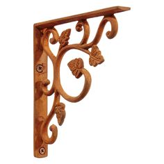 an ornate wooden bracket with leaves and flowers