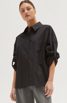 Evie Tie Back Poplin Shirt 100% COTTON -Button front placket -Poplin shirt -Tie back detail -Wide cuffed sleeve hem Model height is 5'9" wearing a small size S Oversized Rolled Sleeves Work Shirt, Oversized Shirt With Rolled Sleeves For Work, Oversized Workwear Shirt With Rolled Sleeves, Relaxed Fit Shirt With Cuffed Sleeves And Shirttail Hem, Black Button-up Top With Cuffed Sleeves, Fall Poplin Button-up Shirt, Relaxed Fit Button-up Shirt With Cuffed Sleeves, Office Shirt With Rolled Sleeves Button-up, Solid Color Shirt With Cuffed Sleeves For Work