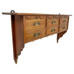 an old wooden dresser with many drawers on it's sides and one drawer open