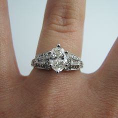 "For sale: (1) d863 Stunning 14k White Gold Engagement Ring PLEASE READ ENTIRE DESCRIPTION BEFORE PURCHASING Pre-owned item. Good condition. Please see pictures for details. Sold as is, as seen on pictures. This ring contains 35 diamonds. The centerpiece is oval cut; two diamonds are baguette cut; 32 are round cut. This ring is stamped on the inside of the shank. Has GIA Certificate on center oval diamond. See picture for details. Specifics: 14k White gold Diamonds: 1.40TCW Size: 6.75 (U.S.) Wid Fine Jewelry With Gia Certified Marquise Cut, Gia Certified Marquise Cut Fine Jewelry, Gia Certified Marquise Fine Jewelry, Elegant Gia Certified Marquise Wedding Ring, Gia Certified Marquise Jewelry For Wedding, Classic Marquise Sterling Silver Wedding Ring, Gia Certified Timeless Marquise Cut Wedding Ring, Gia Certified Marquise Luxury Jewelry, Platinum Marquise Jewelry With Center Stone