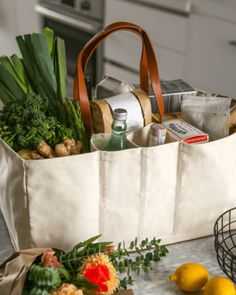 a grocery bag filled with groceries sitting on top of a counter next to lemons