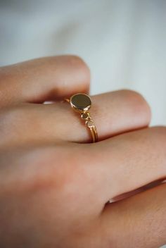 A large gold pebble sits on top of a delicate gold stacking ring. The band measures approximately 1mm in width. This ring is made entirely out of SOLID 14K GOLD metal. We make each 14K Gold pebble by hand so that each ring will look slightly unique — just like pebbles found in nature. We lightly hammered the band for a bright, reflective shine. Every piece is organic and unique — no two Hannah Naomi pieces are exactly alike.Hand-crafted to order in our Portland, OR studio. Yellow Gold Brass Stackable Promise Rings, Yellow Gold Brass Stackable Rings, Gold Stackable Signet Ring In Recycled Gold, Gold Oval Stackable Midi Rings, Yellow Gold Engraved Ring With Recycled Material, Yellow Gold Engraved Ring With Recycled Gold, Gold Midi Rings Of Recycled Gold, Everyday Yellow Gold Recycled Gold Signet Ring, 14k Gold Oval Midi Rings