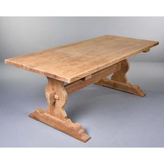 a large wooden table with two legs on the top and one leg raised to the side