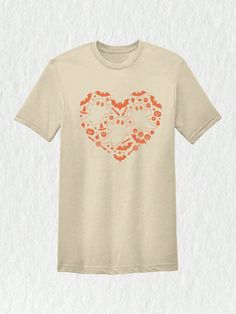 a white t - shirt with an orange heart on it