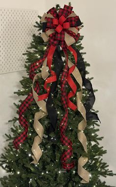 a christmas tree decorated with ribbon and bows