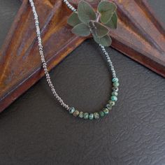 A dainty beaded necklace in a combination of faceted African turquoise, which is a form of jasper stone, and small gunmetal silver seed beads. The seed beads vary slightly in size, giving the piece a bit of a rustic vibe. The necklace is finished with a silver plated hook and eye closure. An optional silver plated 2-inch extender chain is available for added versatility.  Necklace length: 16 inches; optional 2" extender chain is available Your necklace will arrive gift wrapped. Beaded Necklace Collection: https://www.etsy.com/shop/BonArtsStudio?ref=seller-platform-mcnav&section_id=17053954 See What's New: https://www.etsy.com/shop/BonArtsStudio?ref=seller-platform-mcnav&section_id=23290134 My Shop Link: https://www.etsy.com/shop/BonArtsStudio Please check your Etsy account for messages in Silver Turquoise Necklace With Faceted Round Beads, Silver Turquoise Necklace With Spacer Beads For Gift, Minimalist Silver Beaded Necklace With Faceted Beads, Layering Jewelry, Necklace Collection, African Turquoise, Bead Chain, Layered Jewelry, Jasper Stone