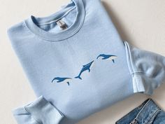 Embroidered Trio of Blue Whale Sweatshirt, Embroidered Blue Whale Shirt, Whale Shirt, Blue Whale Tshirt, Ocean Shirt Fish Shirt Marine Shirt, CozyGenZ This Embroidered Trio of Blue Whales Sweatshirt is a must have for ocean and whale lovers! Perfect for whale-watching. What's better than looking cute and warm with your favorite sealife in the colder month. Our crewnecks are made from the highest quality fabric for an incredibly soft and comfortable fit, with advanced printing and embroidery to e Blue Embroidered Crew T-shirt, Light Blue Embroidered Tops With Crew Neck, Blue Embroidered Relaxed Fit T-shirt, Blue Embroidered Crew Sweatshirt, Blue Embroidered Crew Neck Top, Blue Embroidered Crew Neck T-shirt, Whale Sweatshirt, Ocean Shirt, Blue Whales