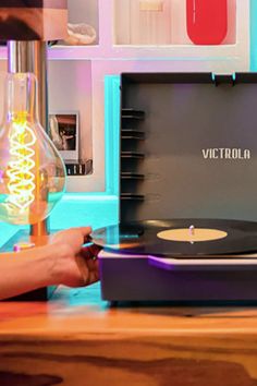 a record player sitting on top of a wooden table