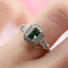 Gorgeous Vintage Inspired Tourmaline Ring ►Made of solid sterling silver with rhodium finish (925) ►Accented With Simulated Diamonds (CZ) ►Average band width: 2.3 mm ►Halo size: 9.9mm x 8.3mm Center Stone: Tourmaline Shape: Emerald Measurements: 4.0 x 6.0 mm Carat Weight: 0.7 ct. (approx.) Gemstone creation: 100% Natural Hardness: 7-7.5 (Mohs scale) ✓ 100% Nickel-Free ✓ Hypoallergenic ✓ Comfort Fit ✓ Free Ring Box ✓ Free USA Shipping *All listing photos are subject to copyright. *All rights rese Formal Green Sapphire Birthstone Ring, Classic Green Ring For Promise, Classic Cluster Ring With May Birthstone, Classic Diamond Ring With Accent Stones For May Birthstone, Classic Promise Diamond Ring For May Birthstone, Classic Cluster Ring With Halo Setting And May Birthstone, Classic Green Halo Ring With Accent Stones, Classic Green Halo Ring For Promise, Classic Emerald Cut Crystal Promise Ring