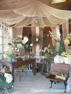 a room filled with lots of furniture and flowers