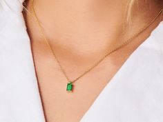 A dainty stone and delicate metallic chain are combined to create this Gold Pendant Necklace in bright emerald, your new favorite wear-anywhere accessory. Emerald is the birthstone of May. High quality lab created emerald stone Made of 14K gold plated sterling silver Pendant size: 10mm x 6mm with 16" chain Hypoallergenic, nickel and lead free Tarnish resistant Silver Emerald Pendant Necklace, Emerald Necklace Pendant, Indian Jewelry Earrings, Emerald Pendant, May Birthstone, Emerald Necklace, 14k Gold Necklace, Pretty Necklaces, Emerald Stone