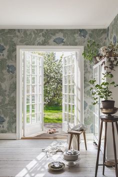 an open door leading to a lush green yard