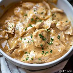 a white bowl filled with meat and gravy