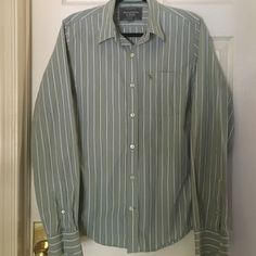 This Is A Beautiful Pale Green Button Down Shirt With Navy And Cream Stripes. Chest Pocket With The Moose Symbol, And Long Sleeves With Two Buttons. Never Worn. Striped Cotton Shirt For Semi-formal Occasions, Green Collared Shirt For Semi-formal Occasions, Classic Green Business Casual Shirt, Green Cotton Shirt With Button Cuffs, Casual Striped Button-up Dress Shirt, Green Cotton Business Casual Shirt, Green Cotton Shirt For Business Casual, Striped Top With Spread Collar And Button Closure, Striped Top With Button Closure And Spread Collar