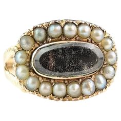 This charming antique Victorian Mourning ring is full of character and alluring melancholy romance as mourning pieces are usually both beautiful and sometimes sad reminders of sacre loved ones. This has so many elements of Georgian styling to it borrowing it's design from earlier times with the central oval Hairwork panel bejewelled with a halo of creamy seed pearls. It has a decorative gadrooned band with engraved split or bifurcated shoulders. The reverse is engraved with a personal inscription. A charming antique mourning ring with stacks of character. Marks and era: Fully hallmarked on the inner band for 9ct gold, Birmingham assay office, date mark ineligible. Condition: Fair used condition overall, some age commensurate surface wear and signs of use, evidence of soft solder where the Luxury Victorian Oval Pearl Ring, Victorian Gold Collectible Rings, Vintage Onyx Ring Victorian, Victorian Gold Pearl Ring With Gemstone, Pearl Halo Ring, Victorian Cluster Ring In 14k Gold, Oval Shaped, Seed Pearl, Halo Rings, Cluster Ring