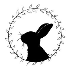 a black and white silhouette of a rabbit in a circle with leaves on it's head