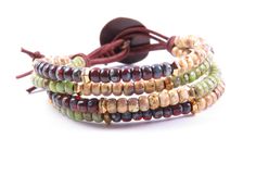 three bracelets with beads and leather cord on a white background, one is multicolored