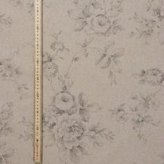 a ruler is next to a floral print fabric