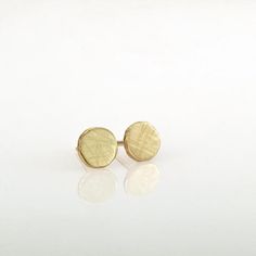 Gold earrings, round simple and perfect for every day’s wear. These organic stud earrings are hand fabricated from  yellow 14k solid gold. I melted the gold and then hammered it to its irregular shape. No two are ever identical; each has a unique and organic look.The edges of the pebbles are rough, while the flat surface has a delicately scratched brushed finish. These are classic, minimalist, “wear with everything” gold earrings - a perfect gift, or a treat for yourself.Earrings diameter is app 14k Yellow Gold Circle Earrings, Classic Round Earrings In Recycled Gold, Classic Hammered Earrings For Everyday, Classic Round Recycled Gold Earrings, Hypoallergenic Round Earrings In Recycled Gold, Dainty Recycled Gold Earrings, Hand Forged 14k Gold Minimalist Earrings, Minimalist Yellow Gold Earrings For Gift, Dainty Yellow Gold Circular Earrings