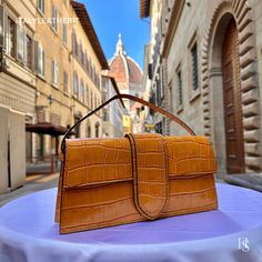 This bag has been made of the best genuine leather by local master crafters of Florence in Italy, designed for women who only accept premium Italian quality and luxury leather bags and modern Italian fashion. . Size: Width:   27 cm/10.75 inch Height:  14 cm/5.50 inch Depth:    6 cm/2.25 inch . The story of this bag: Once upon a time, in the heart of Florence, there was a small leather workshop run by a group of skilled artisans. The workshop had been passed down from generation to generation, and each artisan had inherited a passion for creating beautiful leather goods that reflected the unique beauty and history of Florence. One of the artisans was a woman named Elena, who had been crafting leather bags for over 20 years. Elena had a keen eye for design and a dedication to her craft that Luxury Satchel Baguette Bag For Daily Use, High-end Satchel Baguette Bag For Daily Use, High-end Brown Handheld Box Bag, High-end Handheld Brown Box Bag, High-end Baguette Bag With Detachable Handle For Daily Use, Luxury Brown Rectangular Bag, Designer Brown Baguette Bag With Top Carry Handle, High-end Rectangular Baguette Bag For Everyday Use, Designer Brown Baguette Bag With Top Handle