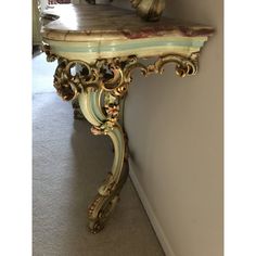 an ornately decorated console table against a wall