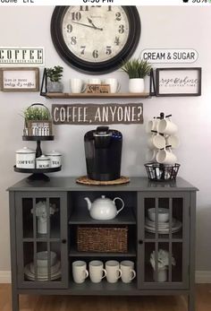 a coffee bar with a clock on the wall above it and other items around it