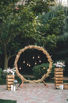 an outdoor wedding setup with candles and wreath