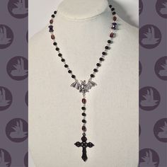 purple gothic rosary! Size is adjustable and can be made bigger/to a specific size just message me! Made with glass and plastic beads. (: Purple Cross Necklace, Handmade Adjustable Purple Rosary, Purple Rosary, Gothic Rosary, Purple Gothic, Purple Cross, Alt Clothes, Beaded Necklaces, Plastic Beads