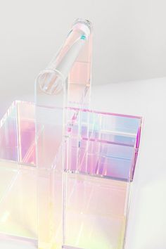 three clear plastic containers sitting on top of a white table next to a toothbrush holder