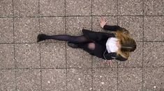 a woman is laying on the ground with headphones