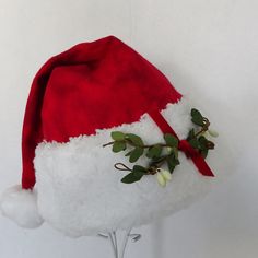 "Get kisses galore this holiday season with a mistletoe Santa hat. This festive Santa hat is made up in a cozy red flannel tie dye cotton fabric. Great novelty party hat. Hat is styled as the traditional cone stocking cap for Santa. Red tie dye flannel is accented with a white faux Sherpa fur fabric trim and a sprig of artificial mistletoe tied with a red velvet ribbon accent is stitched on the fur. Proportions of the hat are generous and will fit most head sizes, ladies or gents. Hat is a soft Oversized Santa Hat, Tie Dye Christmas, Las Vegas Christmas, Red Tie Dye, Holiday Hats, Santa Claus Hat, Stocking Cap, Red Flannel, Tie Dye Cotton