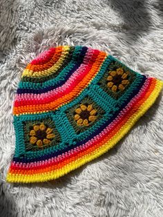 Meet this adorable rainbow sunflower sun hat made with all acrylic scrap yarns. Perfectly lightweight for summer with a floppy brim to shield your eyes from the sun's rays. Brighten up any outfit with this eclectic piece🌈💕 One size fits most (average-22.5 inch head circumference) MEASUREMENTS  *Circumference: 22 inches around when lying flat/unstretched *Diameter across top (rainbow part): 9.5 inches *Sunflower square dimensions: 4 inch wide x 3.5 inches long *Brim width: 2 inches *All scrap acrylic yarn Hand wash with cool/warm water and air dry for best results. Do not bleach or iron. Feel free to message me any questions or concerns you may have🤗 Much love Adjustable Multicolor Whimsical Crochet Hat, Playful Summer Crochet Hat, Yellow Knitted Beach Hat, Multicolor Crochet Sun Hat For Summer, Summer Multicolor Crochet Sun Hat, Summer Crochet Multicolor Sun Hat, Playful Multicolor Bucket Hat, Handmade Multicolor Acrylic Crochet Hat, Multicolor Crochet Yarn Cap