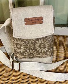 a brown and white purse sitting on top of a wicker basket