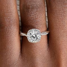 a woman's hand with a diamond ring on her finger and an engagement band