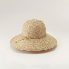 Helen Kaminski Women's Delphina Natural HAT50185 A modern taken on elegance, Delphina delivers minimal style at its best. Constructed from hand plaited raffia braid and taking up to three days to complete, this style is a timeless piece. Offering a classic round crown and down angled wide 10cm brim, it's finished with a hand rolled raffia tie and signature seed insignia. Styles can be adjusted with either a hand rolled raffia string around the crown or inner band and tie. You can expect to reduc Classic Woven Straw Hat, Woven Short Brim Boater Hat, Elegant Braided Hats For Spring, Elegant Braided Brimmed Sun Hat, Elegant Braided Hat For Spring, Elegant Adjustable Braided Hat, Natural Woven Fedora, Elegant Braided Straw Hat With Flat Brim, Elegant Braided Toquilla Straw Hat