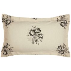 a black and white flowered pillow on a white background with an embroidered border in the center