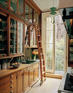 the ladder is leaning up against the wall in the kitchen, leading to the window