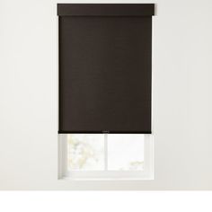 a black roller shade hanging on the side of a window in front of a white wall