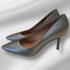 Calvin Klein Gayle Pump, Grey / Pewter / Silver, Size 8.5, 3 1/4” Heel, Nwot Sleek, Simple And Sophisticated, This Pointy-Toe Pump With A Polished Rand In Back Is Comfortable Enough To Get You Through Hectic Workdays. 3 1/4" Heel - Perfect Heel Height Cushioned Footbed Leather Upper/Synthetic Lining And Sole Imported Women's Shoes Item #6218692 Retail: $108 Metallic Silver Heels With 4-inch Heel For Formal Occasions, Classic Silver Heels With 4-inch Heel, Silver Pointed Toe Heels For Galas, Metallic Closed Toe Heels For Formal Occasions, Silver Almond Toe Heels With Sculpted Heel, Silver Court Shoes With 4-inch Heel For Evening, Metallic Heels With Metal Feet For Formal Occasions, Silver Evening Court Shoes With 4-inch Heel, Metallic Silver Heels For Spring Formal