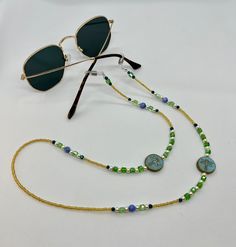 Whether you're headed to a festival, taking a stroll along the beach, or just walking around the block, these sunglass chains are both handy and stylish to bring along for the ride. Convenient if you want to let your glasses hang comfortably on your chest, or put them on to add some flair to any activity you're getting into. Elastic endpieces stretch out and make it easy to slide the chain onto any pair of sunglasses or reading glasses. Each pair is handmade with love in colorful Colorado :) Custom designs are welcome, let me know what you have in mind and I'd love to make it happen! **Photos 3 & 4 are just examples of what they look like on, not necessarily the exact same pair you're looking at. Summer Festival Necklace With Adjustable Chain, Trendy Adjustable Gold Glasses Chain, Bohemian Sunglasses With Uv Protection For Vacation, Summer Beach Necklaces With Adjustable Length, Adjustable Length Necklaces For Summer Beach, Summer Beach Necklace With Adjustable Length, Adjustable Length Necklaces For Beach In Summer, Festival Sunglasses With Uv Protection And Adjustable Fit, Adjustable Festival Sunglasses With Uv Protection