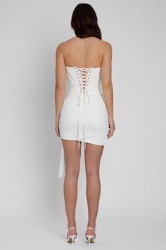 THE dress of the season has arrived - just in time for your all white parties, bachelorette trips and wedding season, meet our Capri Bustier Corset Draped Mini Dress! Cut from a opaque, soft and comfortable fabric that moves with you, this white corset dress sits at a mini length that is complimented by a cross-over drape effect that falls effortless to your side. The strapless bustier top features padded cups and wire detail to provide both shape and security where and when you need it. The cor Corset Draping, White Parties, White Corset Dress, Draped Mini Dress, High Waist Long Skirt, All White Party, Long Skirt Outfits, Strapless Bustier, White Corset