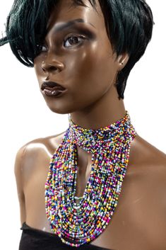 This Enigye beaded choker necklace is an expertly-crafted handmade piece from our artisans in Kenya. The one-size closure at the back ensures a secure and comfortable fit. Enhance your style with this stunning choker necklace and add a touch of elegance to any outfit. Adjustable Beaded Choker, Unique Adjustable Beaded Bib Necklace, Large Round Beads Choker, Adjustable Beaded Bib Necklace For Festivals, Adjustable Beaded Bib Necklace, Festival Beaded Bib Necklace, Unique Adjustable Choker For Parties, Elegant Adjustable Beaded Choker Necklace, Elegant Beaded Choker