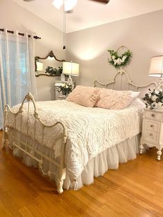 a white bed sitting on top of a wooden floor