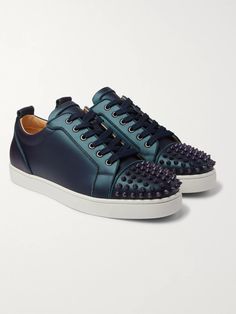 Christian Louboutin's 'Louis Junior' sneakers are decorated with spiked toe caps, a brand signature. This low-top pair has been made in Italy from smooth blue leather that has an iridescent sheen, you'll only catch it under certain light. Designer Studded Low-top Sneakers, Designer Custom Sneakers With Studded Outsoles For Streetwear, Designer Low-top Sneakers With Spikes, Designer Leather Sneakers With Spikes, Custom Leather Sneakers With Spikes And Round Toe, Sporty Spiked Leather Sneakers, Luxury Low-top Custom Sneakers With Rubber Heel Cap, Luxury Spiked Sneakers For Streetwear, Luxury Lace-up Sneakers With Spikes