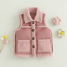 Keep your little snowball warm and comfy this winter season and in style in this stunning pink vest with plush details. Pink Cotton Vest For Fall, Cute Pink Cotton Vest, Pink Cotton Outerwear With Fleece Lining, Cute Pink Outerwear With Pockets, Pink Casual Winter Vest, Casual Pink Winter Vest, Pink Sleeveless Vest With Pockets, Pink Sleeveless Cotton Outerwear, Cute Pink Vest For Spring