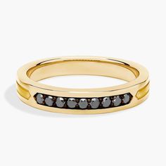 a gold band with black diamonds on it