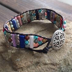 This multi color beaded bracelet for women is stunning and unique. This single wrap bracelet would compliment and outfit you want to wear it with. This bracelet would be a beautiful meaningful gift for your mother on Mother's Day. It will be a gift she can enjoy every day. This leather beaded bracelet is made with a variety of gemstone beads in various sizes and colors. Please choose the size you would like at check out. Adjustable Cuff Bracelet With Colorful Beads For Gifts, Adjustable Cuff Bracelet With Colorful Beads As Gift, Colorful Adjustable Spiritual Jewelry, Multicolor Beaded Wrap Bracelet As Gift, Multicolor Beaded Friendship Wrap Bracelet, Multicolor Hand Wrapped Crystal Bracelet, Hand Wrapped Multicolor Crystal Bracelet, Adjustable Colorful Beads Wrap Bracelet, Multicolor Round Beads Wrap Bracelet For Friendship