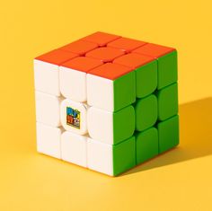 a rubik cube is shown on a yellow background