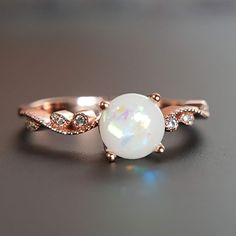 Beautiful handmade item! Here, on Etsy made as simulation only-just resin and white color.  Breastmilk Ring made with white gold plated sterling silver or plated with rose or yellow gold. Opal effect breastmik 7mm rounded shaped stone. Any size available. Rose gold,  or white gold plated options.  Pearl powder or opal effect can be added to this fine breastmilk ring. Beautiful inlaid cubic zirconia surround and accentuate your breastmilk stone while a skin-friendly 925 sterling silver ring core. Round White 14k Rose Gold Jewelry, White Crystal Birthstone Ring With Round Stone, 14k Rose Gold White Jewelry As Gift, White 14k Rose Gold Jewelry As Gift, White Round 14k Rose Gold Jewelry, White 14k Rose Gold Jewelry, Elegant Rose Gold Moonstone Jewelry, Sterling Silver Rose Gold Crystal Ring, Rose Gold Crystal Ring As A Gift