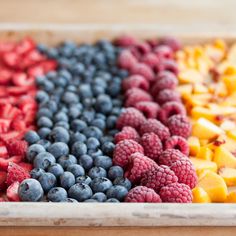 an assortment of fruits in a tray on a table